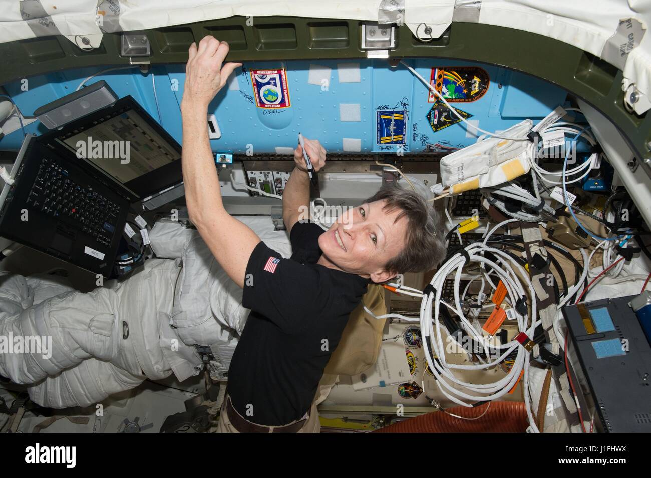 NASA-Expedition 50 erstklassige Crew Mitglied US-amerikanische Astronautin Peggy Whitson unterschreibt ein SCHOTT auf der internationalen Raumstation neben der Expedition 50 Crew Patch 5. März 2017 in der Erdumlaufbahn.       (Foto: NASA Foto /NASA über Planetpix) Stockfoto
