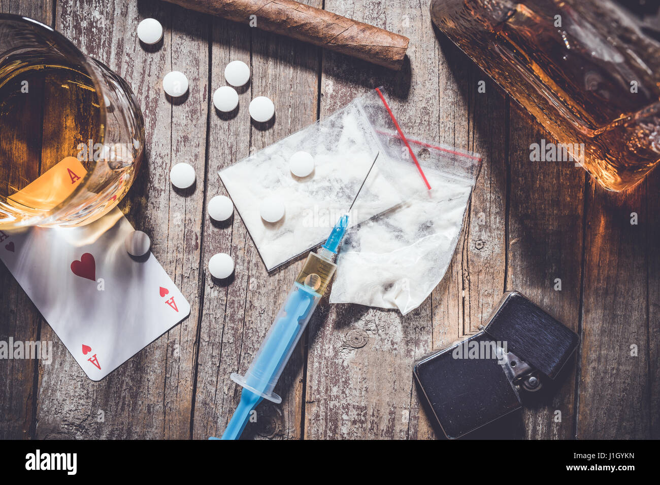 Harte Drogen und Alkohol auf einem alten Holztisch. Nahaufnahme Stockfoto