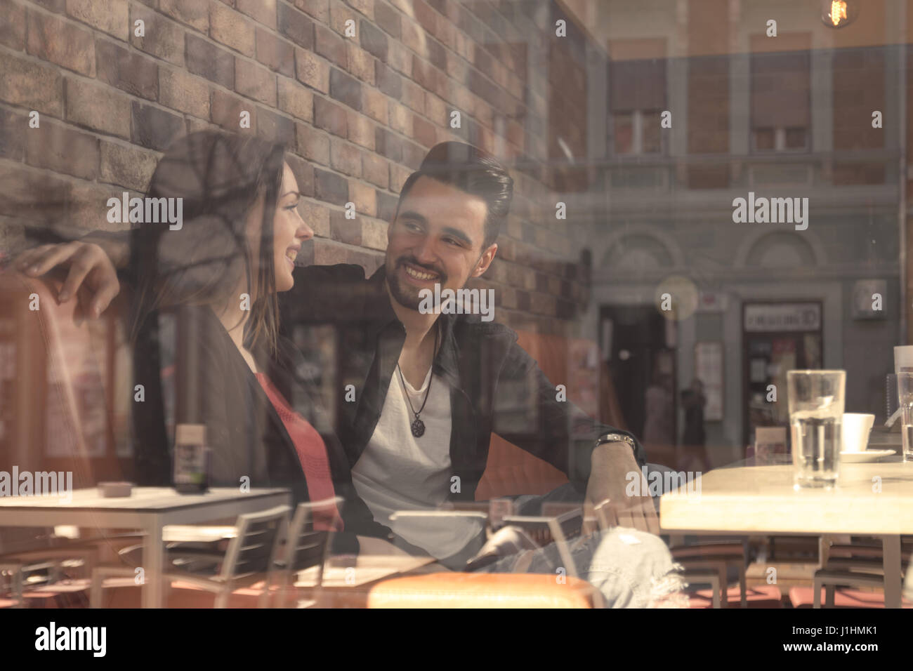 Café junge Erwachsene 20 s paar Frau Mann lächelnd dachte Fenster Reflexion zu schießen Stockfoto