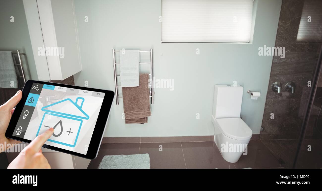 Digitalen Verbund von Hand mit smart home Anwendung auf digital-Tablette im Waschraum Stockfoto