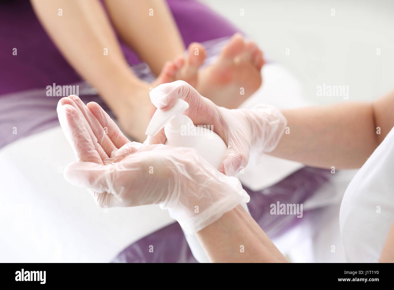 Ätherisches Öl zur Pflege der Haut, schöne Füße. Ein gesunder Fuß Kosmetikerin gilt ein Pflegeprodukt Stockfoto
