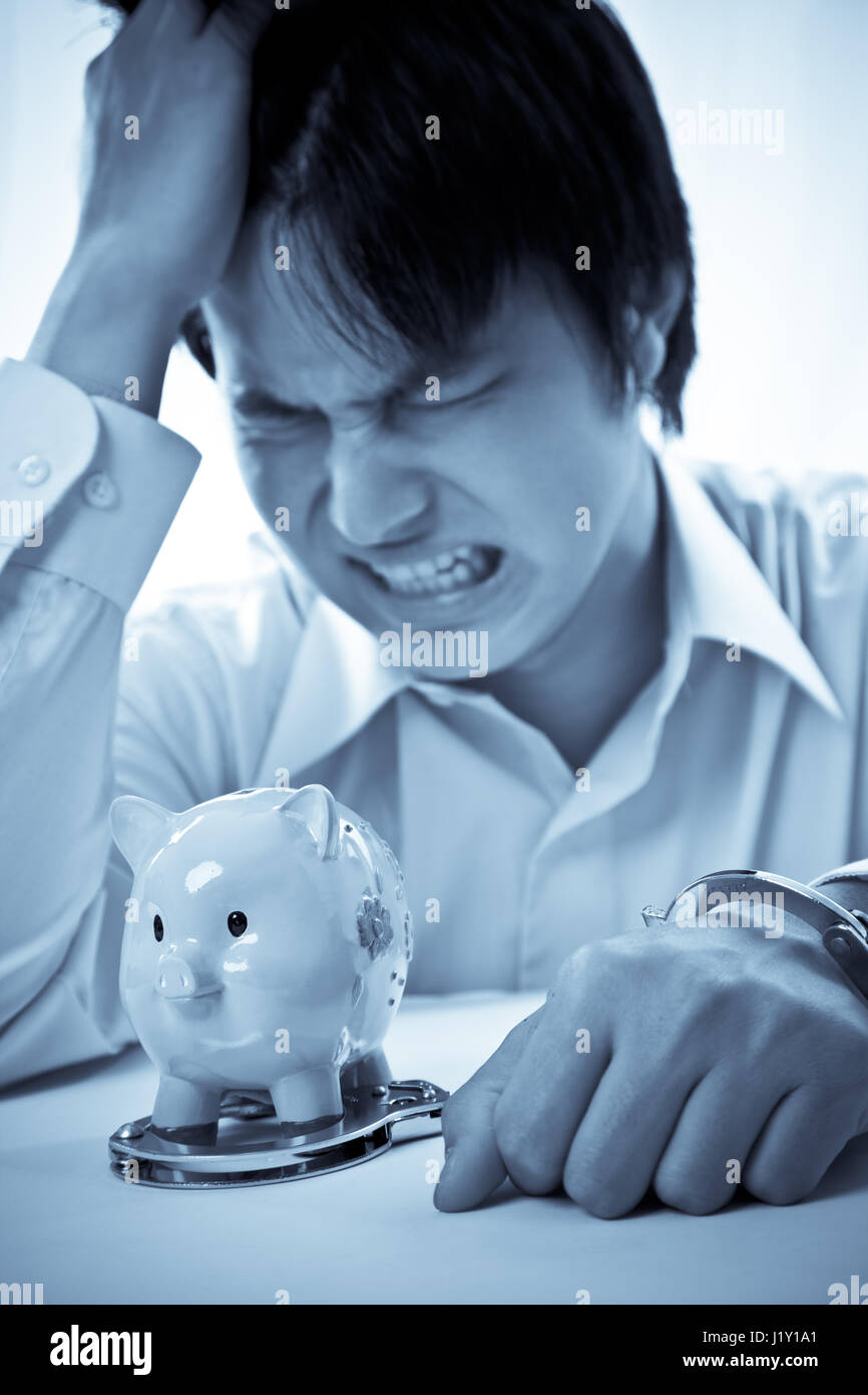 Eine konzeptionelle Schuss von einem asiatischen Geschäftsmann vor finanzieller Not Stockfoto