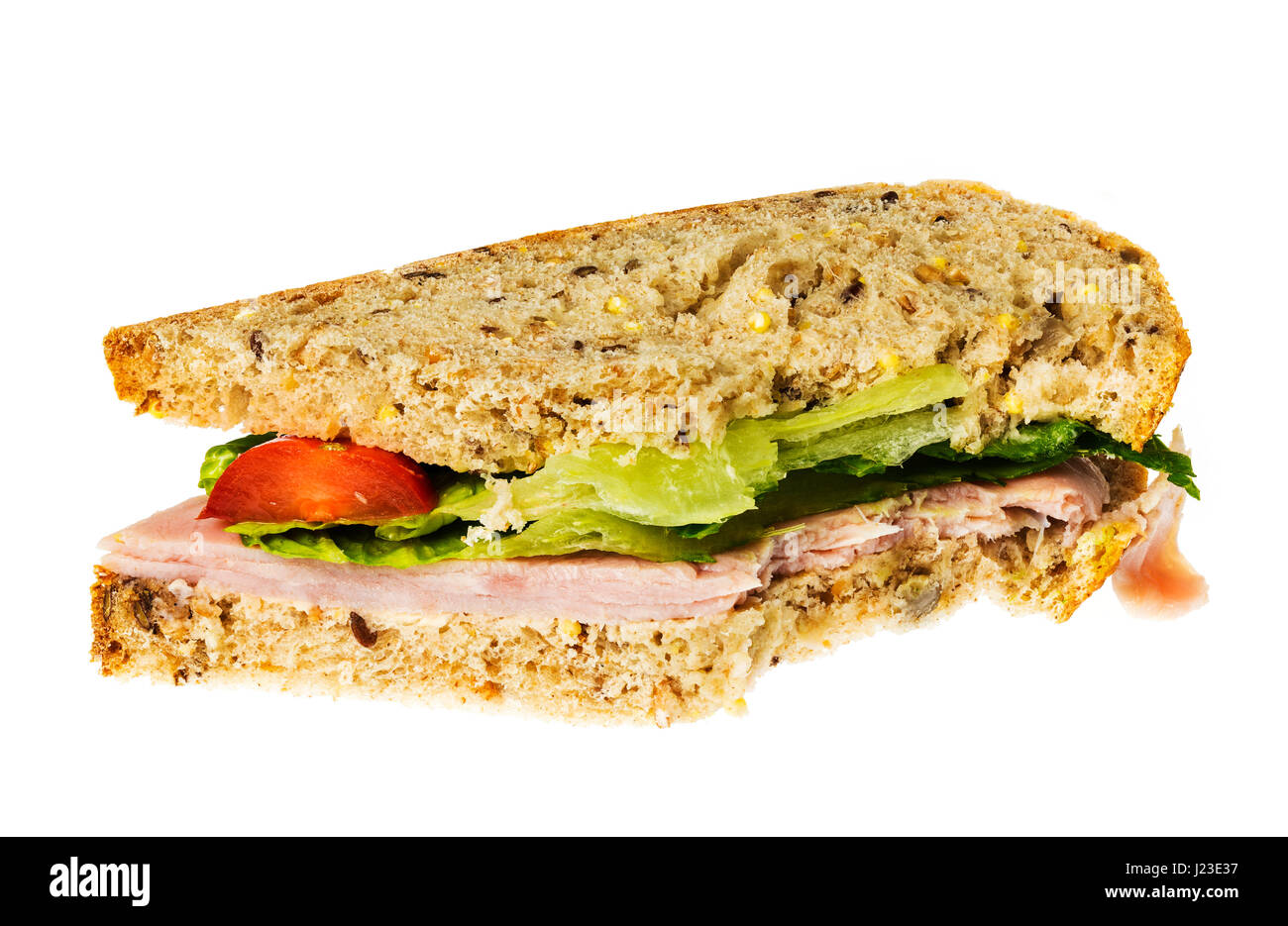 Schinken Sandwich Hälfte mit einem Bissen aus einer Ecke gegessen Stockfoto