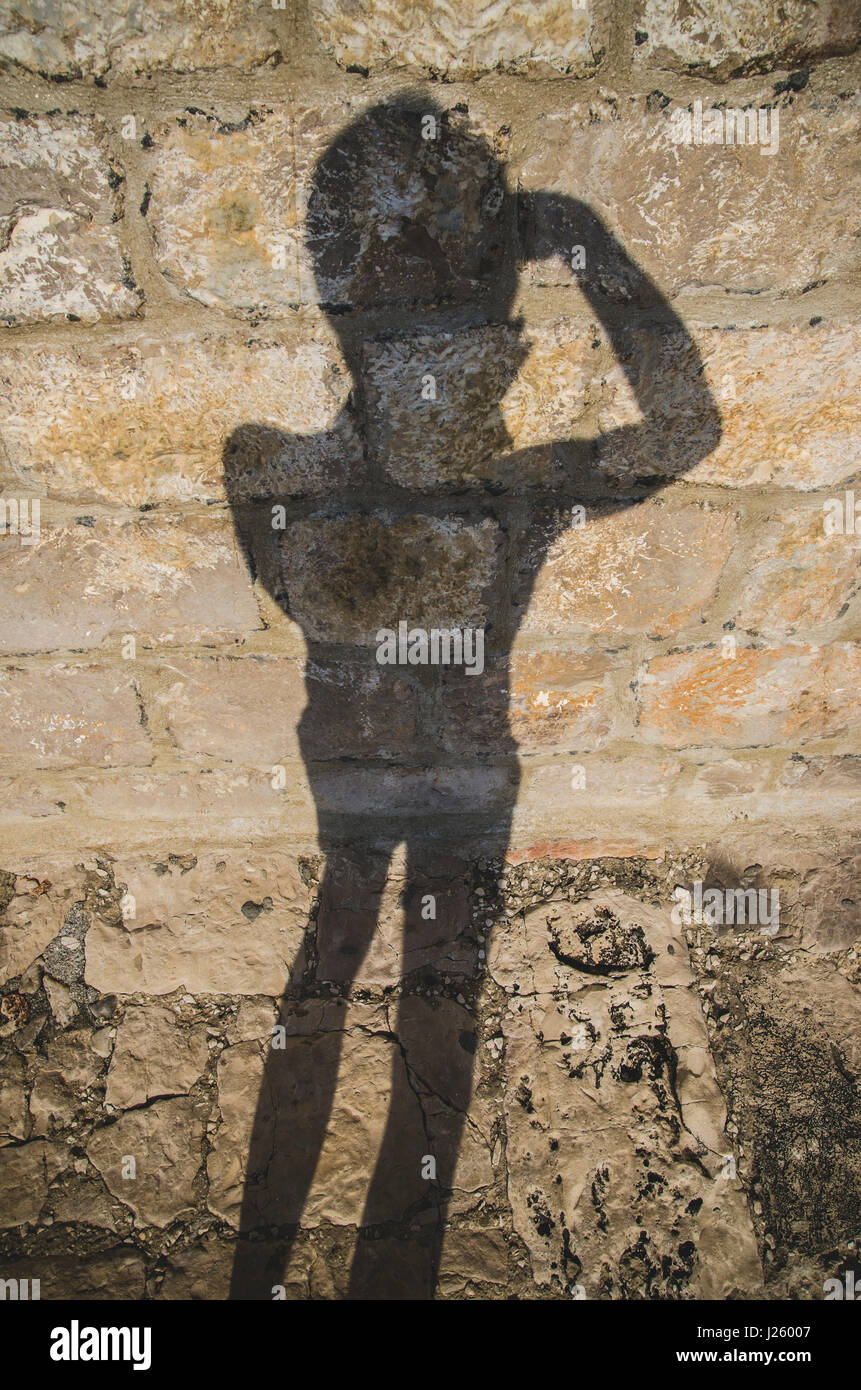 Des Fotografen Schatten auf Steinmauer, Vis, Kroatien Stockfoto