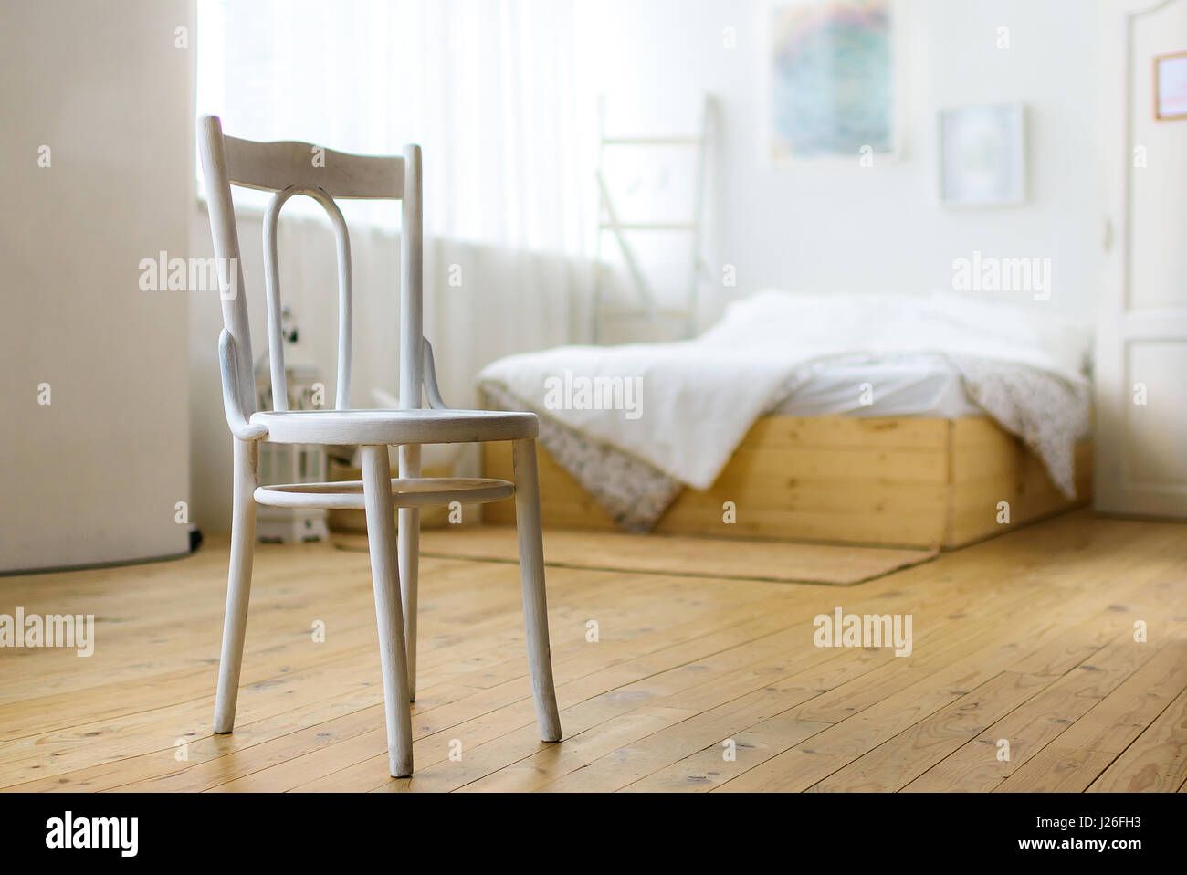 Weißer Stuhl im Schlafzimmer, Bett und Gemälde an der Wand Stockfotografie  - Alamy