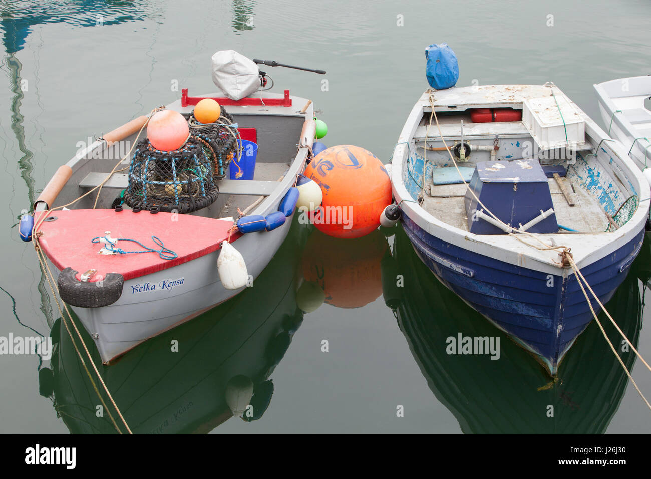 Ein paar kleine offene geschälten Angelboote/Fischerboote in Porthleven Hafen getrennt durch eine große orange Boje Stockfoto