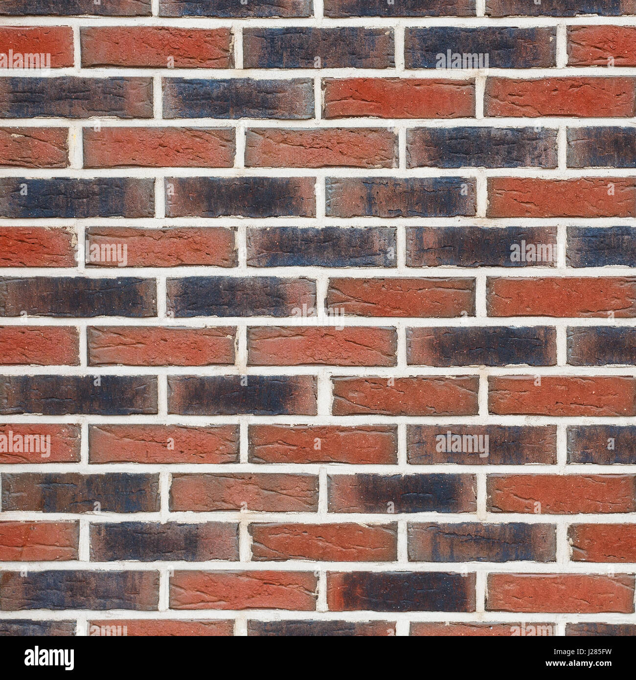 Textur von einer Mauer. Neue Ziegel verschiedene Schatten. Stockfoto