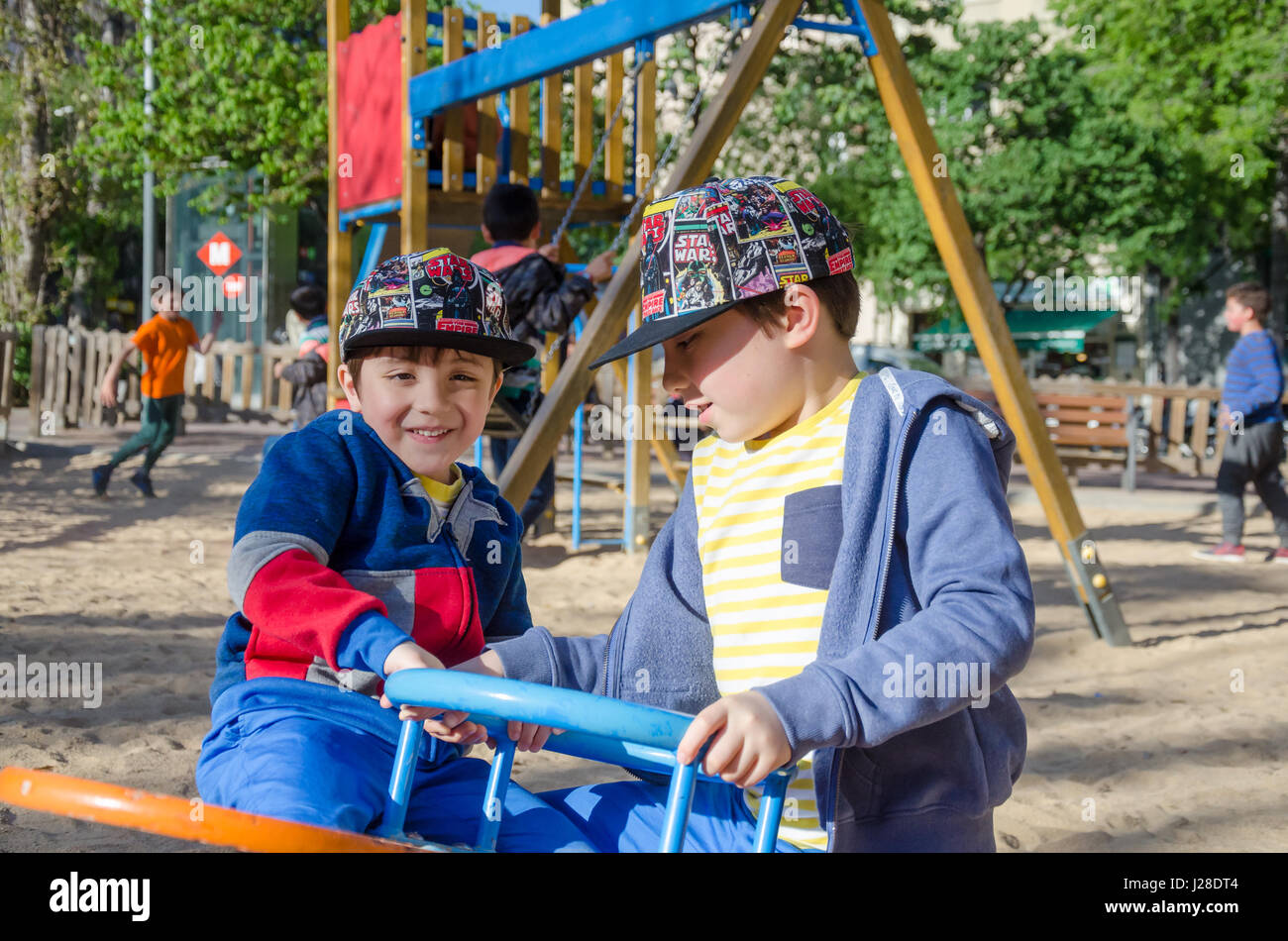 Junge Brüder spielen auf einer Springer-Wippe in einen Kinderspielplatz. Stockfoto