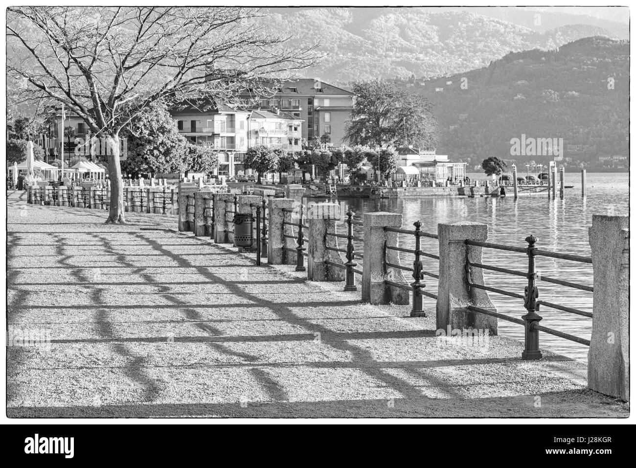 am See Promenade am Wasser früh morgens in Baveno, Lago Maggiore, Italien im April - schwarz / weiß Monochrom Stockfoto