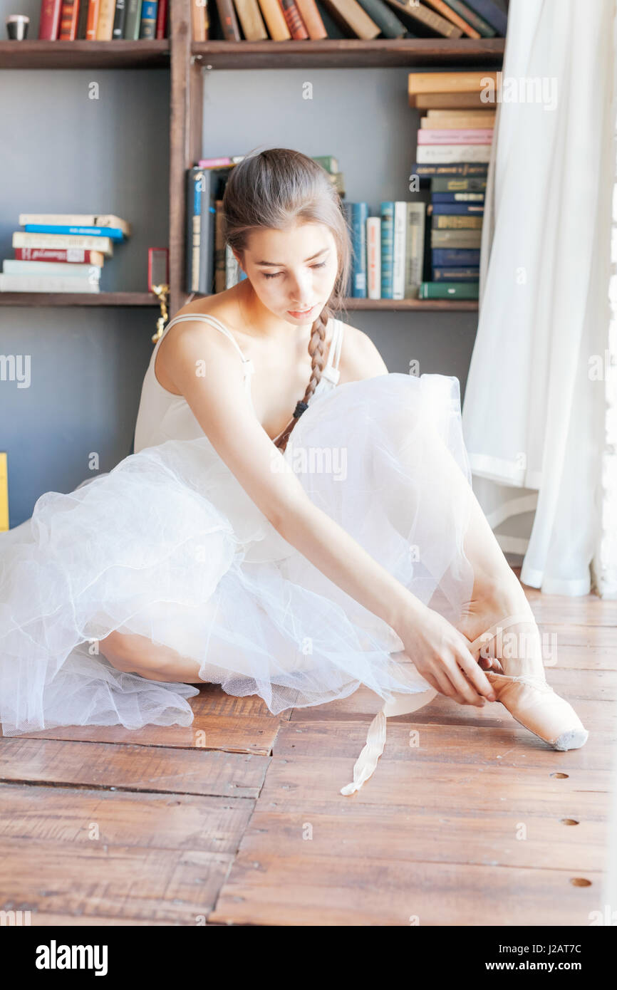 Ballett-Tänzerin Pantoffeln um ihre Knöchel Frau Ballerina Pointe zu binden. Stockfoto