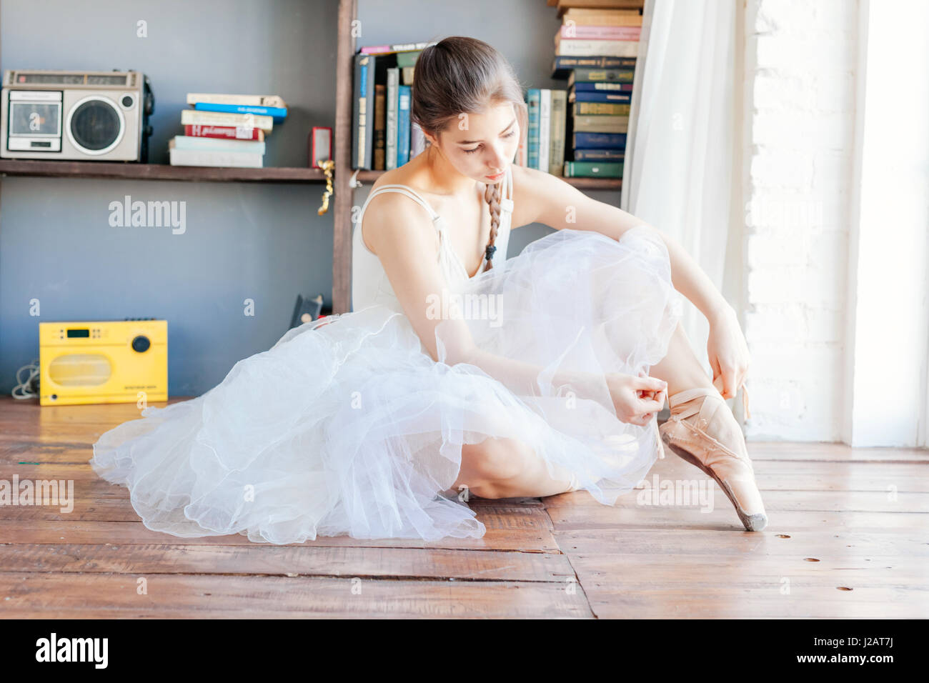 Ballett-Tänzerin Pantoffeln um ihre Knöchel Frau Ballerina Pointe zu binden. Stockfoto