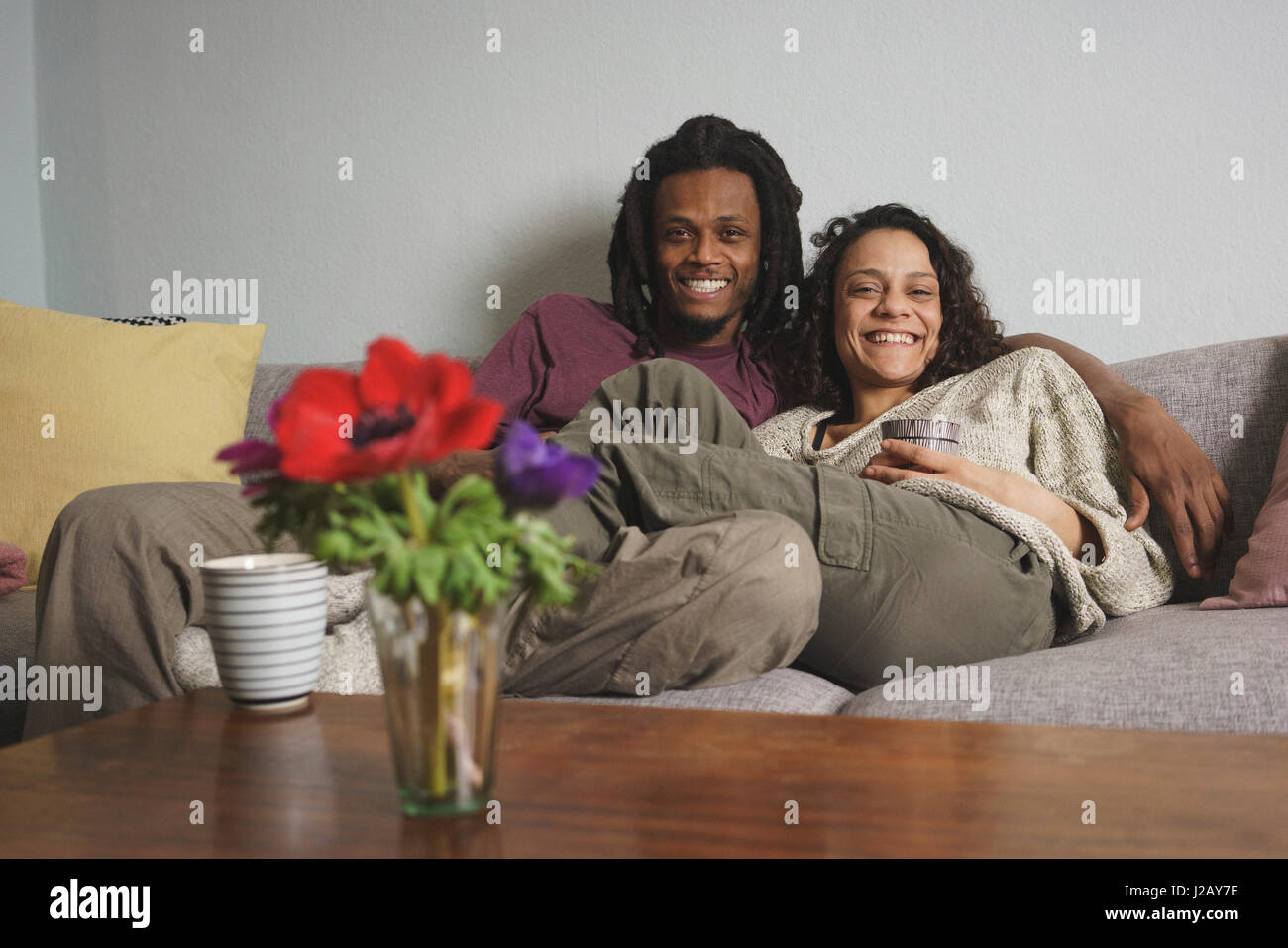 Porträt des multi-ethnischen Brautpaar am Sofa zu Hause entspannen Stockfoto