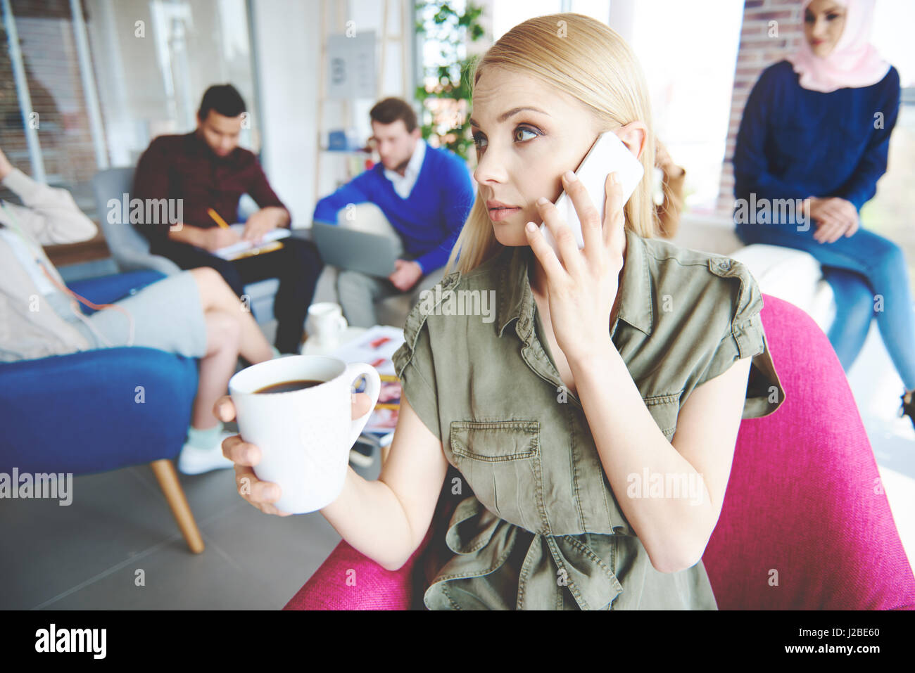 Business-Frau mit Kaffee mit einem Anruf Stockfoto