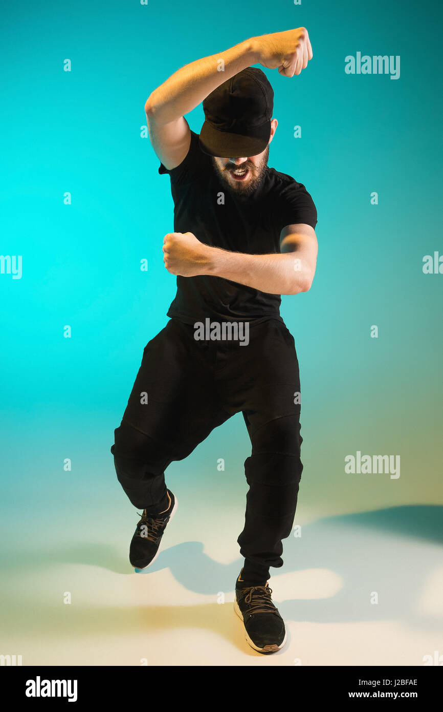 Die Silhouette von einem Hip-Hop-männliche Pause Tänzer tanzen auf farbigen Hintergrund Stockfoto