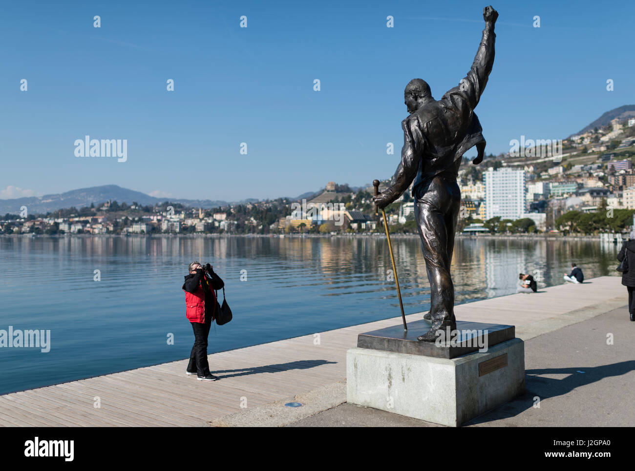 Ein Tourist nimmt ein Bild von der Statue von Freddie Mercury, verstorbenen Sängers der UK-Rock-Band Queen, am Seeufer des Genfer Sees in Montreux, Sw Stockfoto