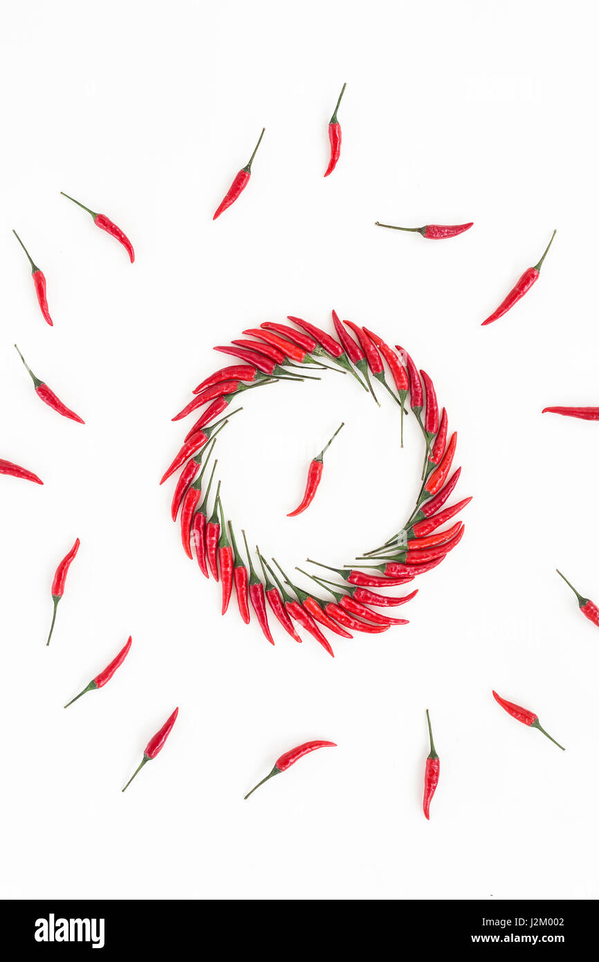 hot Chili Paprika, beliebte Gewürze Konzept - dekorative kreisförmige Figur setzt sich aus mehreren Schoten von roter Paprika, in der Mitte ist eine Hülse, schöne Collage von liegenden Paprika, Draufsicht, flach zu legen Stockfoto