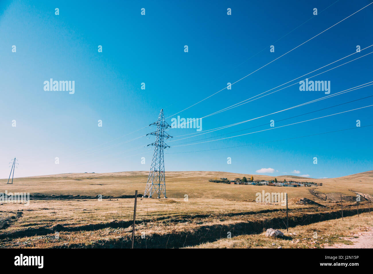 elektrische Energie Übertragung Pylon auf Grasland der Inneren Mongolei gegen blauen Himmel, China Stockfoto
