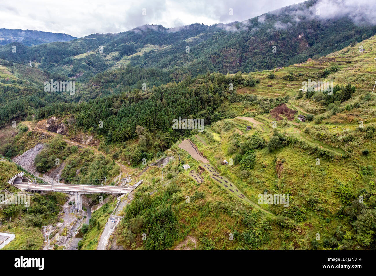 Guizhou, China.  Bewaldete Hänge, Terrassen Landwirtschaft, Autobahnbrücke zwischen zwei Tunneln zwischen Zhaoxing und Kaili. Stockfoto