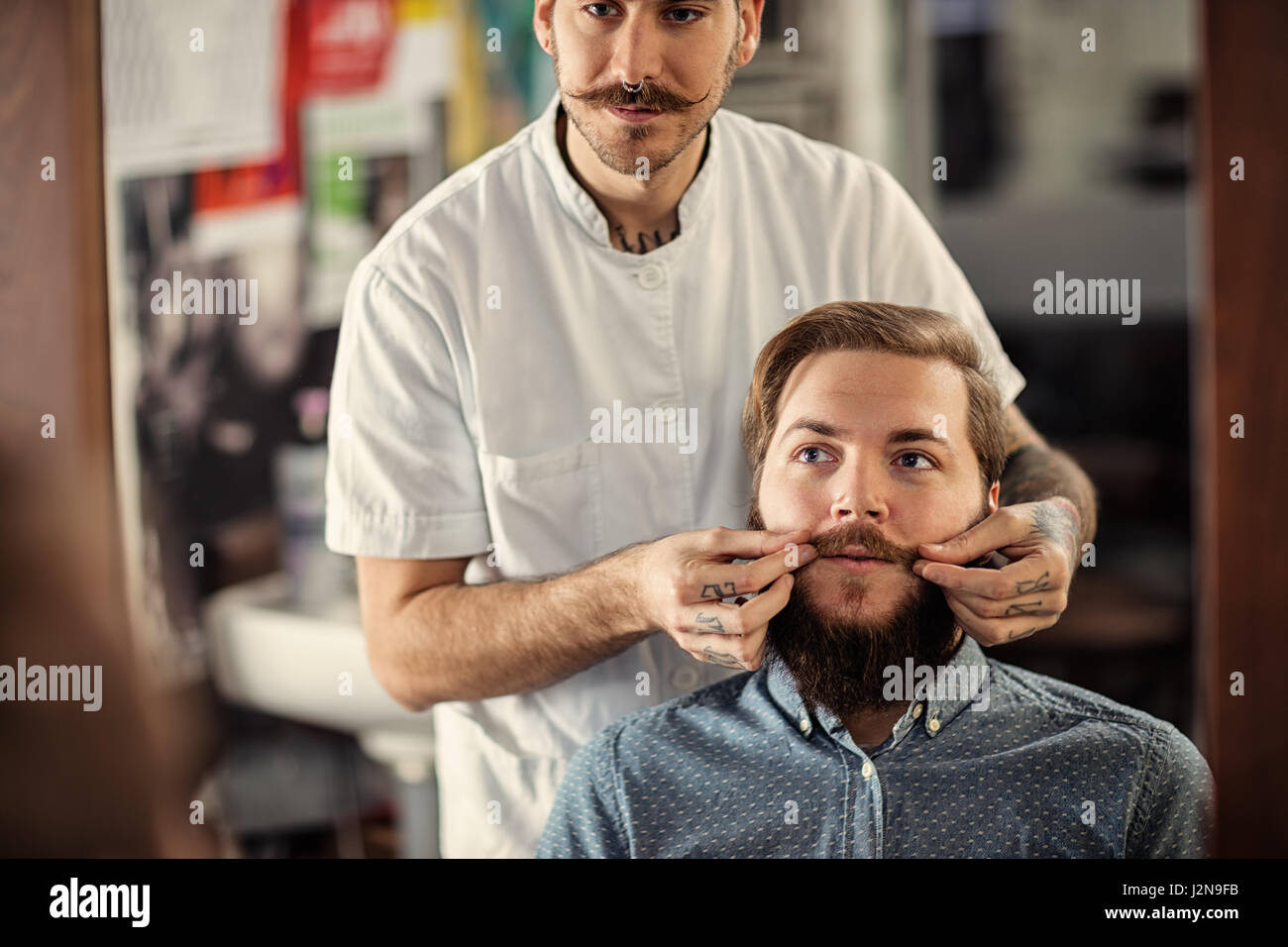 Geschickte männlichen Barbier dient seinen Kunden Schnurrbart Stockfoto