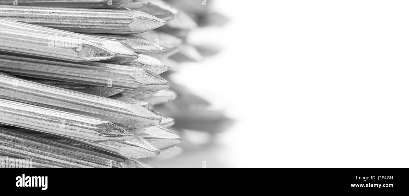 Nahaufnahme von der Randseite konkrete Stahlnägel auf weißem Hintergrund, selektiven Fokus mit Unschärfe Hintergrund Stockfoto