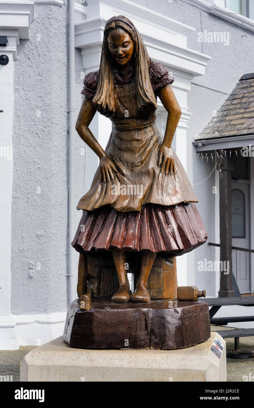 Alice im Wunderland geschnitzte Holzfigur in Llandudno. Stockfoto