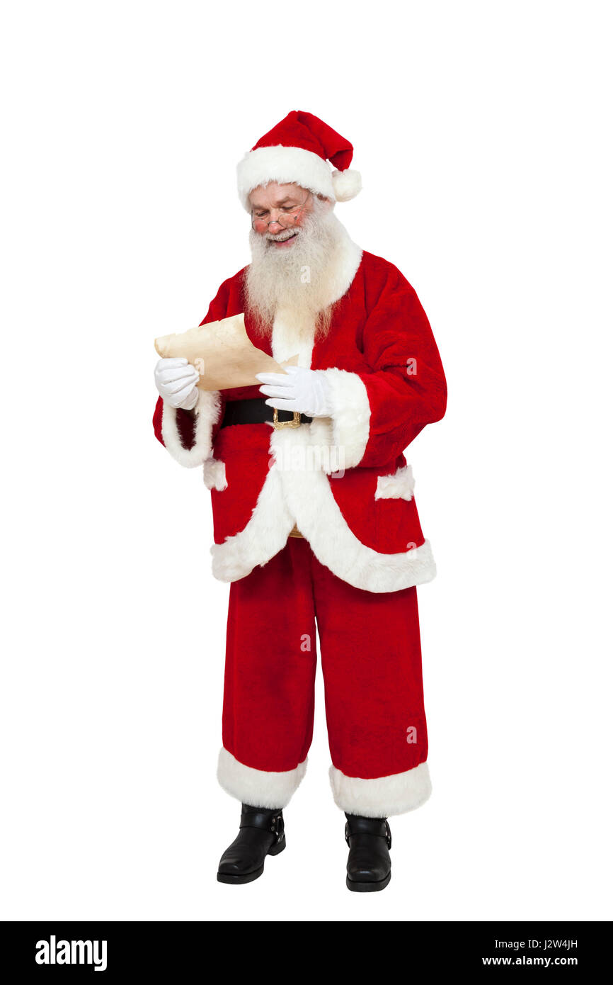 Santa Claus (Ganzkörper) lesen eine Wunschliste (isoliert) Stockfoto