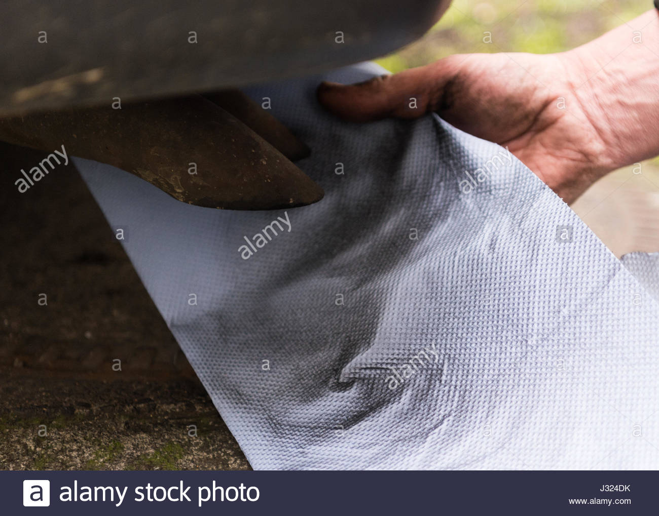 Hamburg, Deutschland. 2. Mai 2017. ILLUSTRATION - Mechaniker hält ein Stück Papier vor einem Abgasrohr von Diesel-Pkw um die Dämpfe 2. Mai 2017 in Hamburg, Deutschland, sichtbar zu machen. Allgemeine treibende Verbote für Dieselfahrzeuge in Hamburg sind nicht geplant. Noch, zwei Straßen drohen Einschränkungen, die lang ersehnten Plan für sauberere Luft (Deutsch: "Luftreinhalteplan") des Senats, der am 2. Mai 2017 vorgelegt wurde, heißt es. Foto: Christophe Gateau/Dpa/Alamy Live News Stockfoto