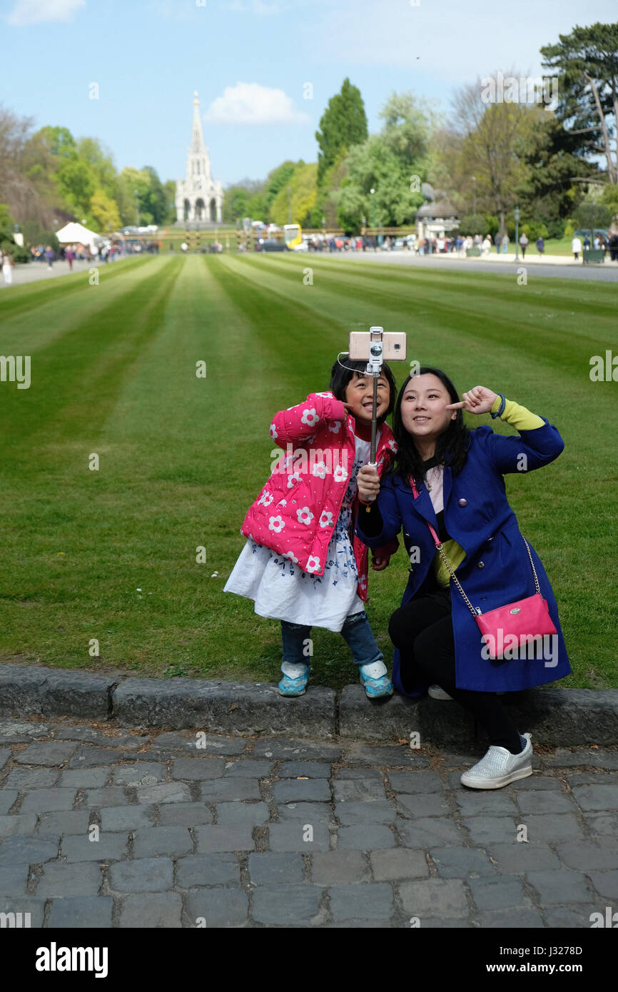 Asiatische Touristen nehmen ein Selbstporträt mit ihrer Tochter in Brüssel von Laeken Stockfoto