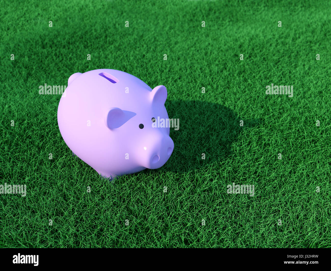 Sparschwein mit Grass Stockfoto