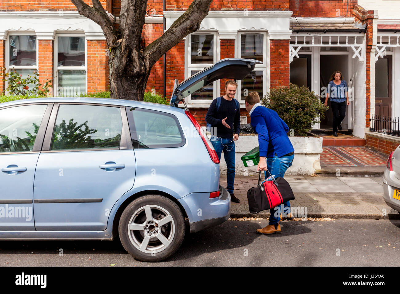 Ein junger Mann begrüßt seine neuen Nachbarn, London, England Stockfoto