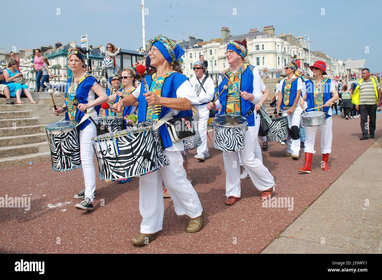 Samba-Band Dende Nation Parade entlang der Strandpromenade des jährlichen St.Leonards Festivals am St.Leonards-on-Sea, England am 12. Juli 2014. Stockfoto