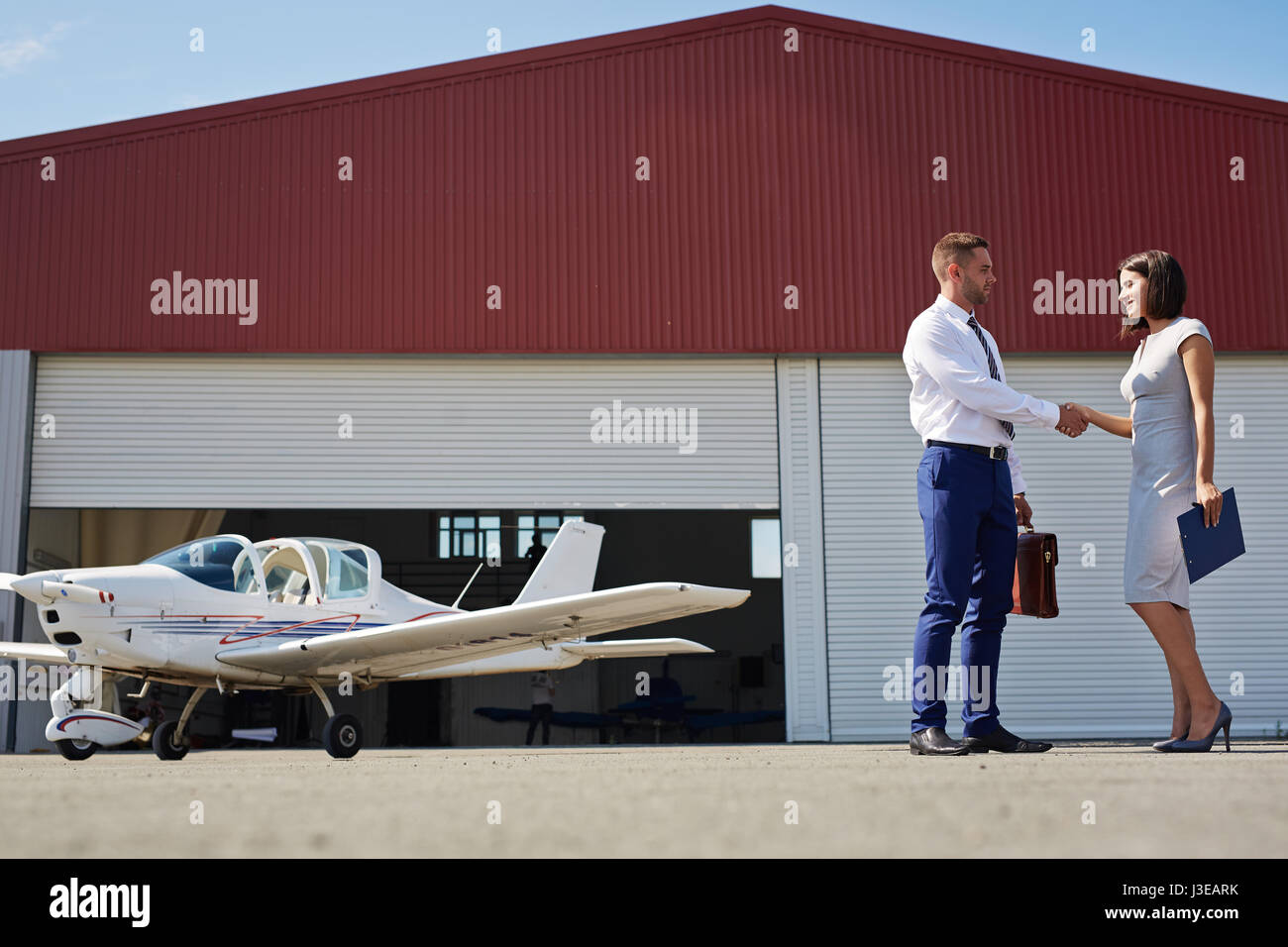 Business Handshake in Flughafen-Bereich Stockfoto