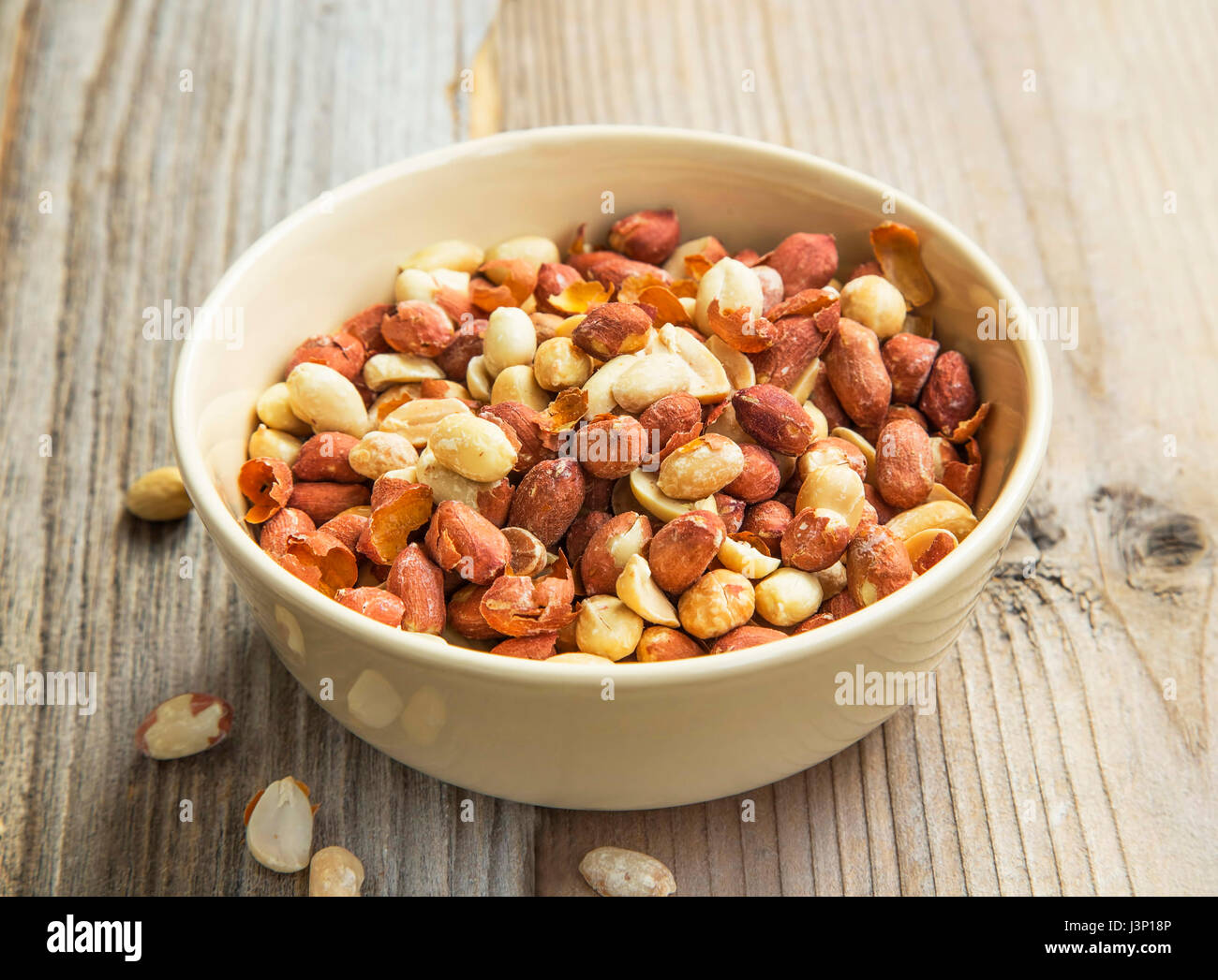 Erdnüsse in einer Schüssel auf hölzernen Hintergrund, snack gesunde Fette Stockfoto
