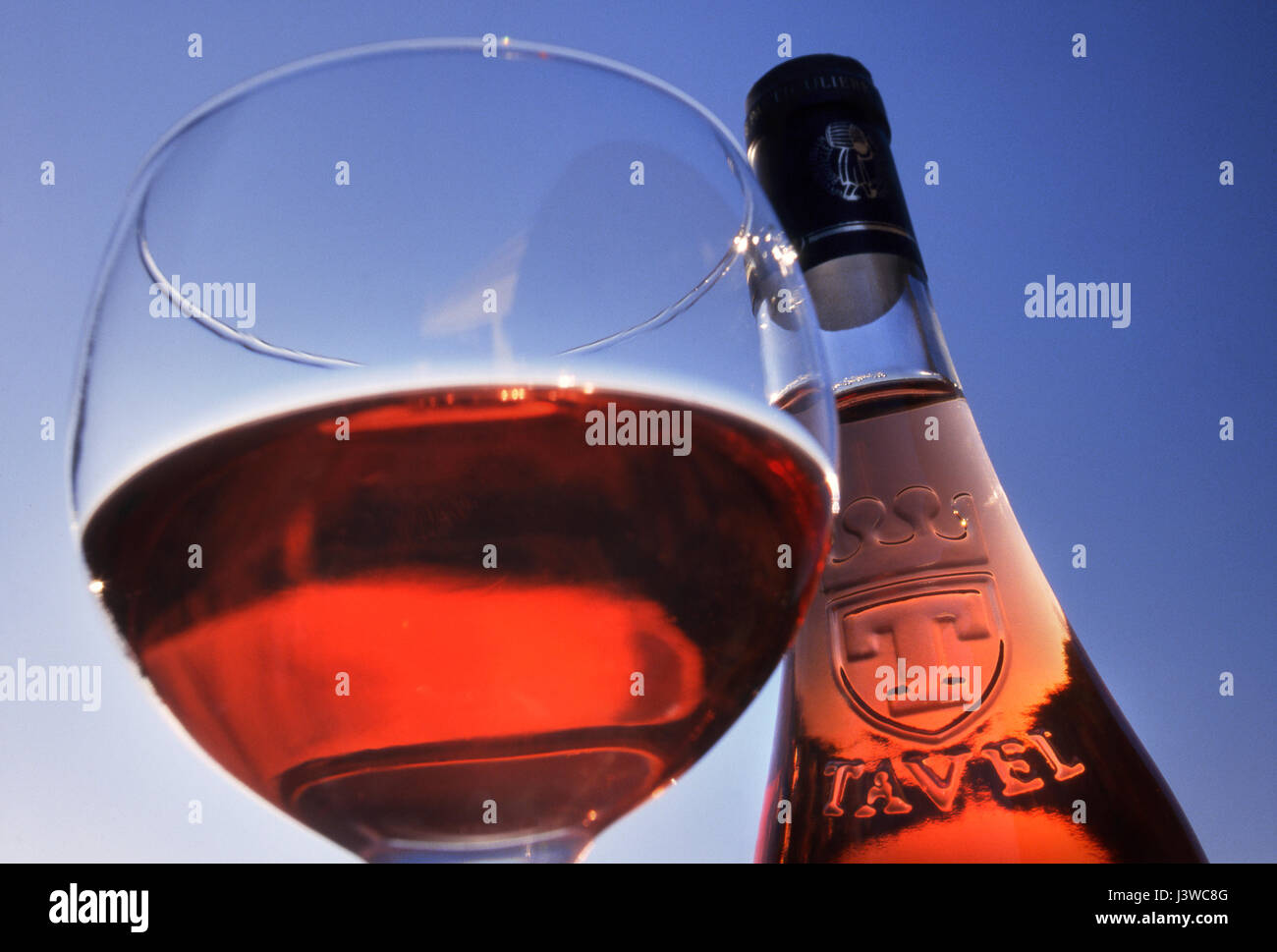 TAVEL ROSÉ Flasche und Glas von Tavel rosé Wein außerhalb im freien gegen reine blaue sonnigen Himmel Gard, Südfrankreich Stockfoto