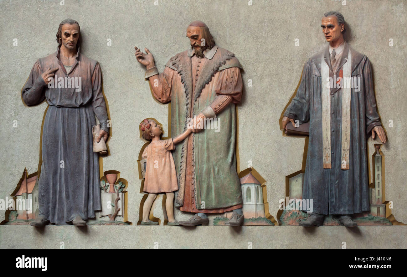 Jan Hus, Johann Amos Comenius und der erste Patriarch der Tschechoslowakischen Hussitischen Kirche Karel Farský (von links nach rechts). Farbige Lehm Relief des tschechischen Bildhauers Jan Znoj (1936-1938) in der Gemeinde Haus der Tschechoslowakischen Hussitischen Kirche (Husův Sbor) im Stadtteil Vinohrady in Prag, Tschechische Republik. Stockfoto
