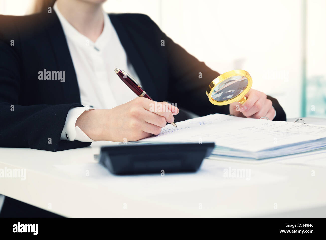 Audit-Konzept - Auditor mit Lupe inspizieren Dokumente in office Stockfoto