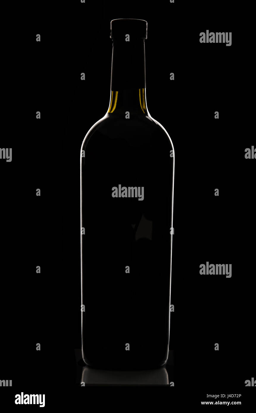 Stilvolle elegante schwarze verkorkten Flasche Wein reflektiert und von Licht auf schwarzem Hintergrund skizziert. Logos entfernt. Stockfoto