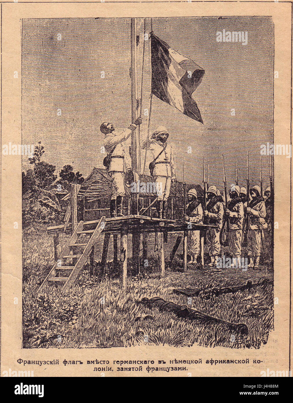 Dieses Bild zeigt den Flaggenwechsel in Afrika während des 20. Jahrhunderts und symbolisiert den Wechsel vom deutschen zum französischen Kolonialeinfluss, der den breiteren Kontext der europäischen Kolonialgeschichte in Afrika widerspiegelt. Stockfoto