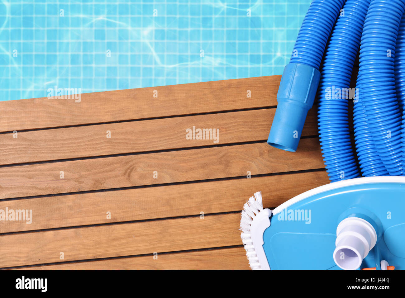 Werkzeuge für die Wartung des Pools auf Holzlatten. Mit Pool mit Wasser und blauen Mosaiken Hintergrund. Horizontale Komposition. Ansicht von oben Stockfoto