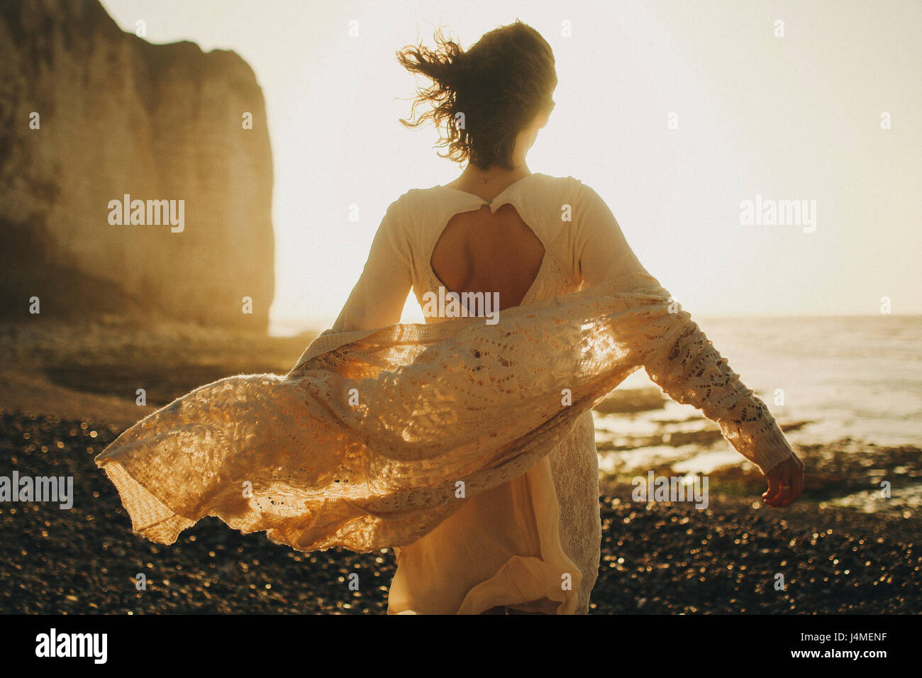 Wind weht Pullover der kaukasischen Frau am Strand Stockfoto