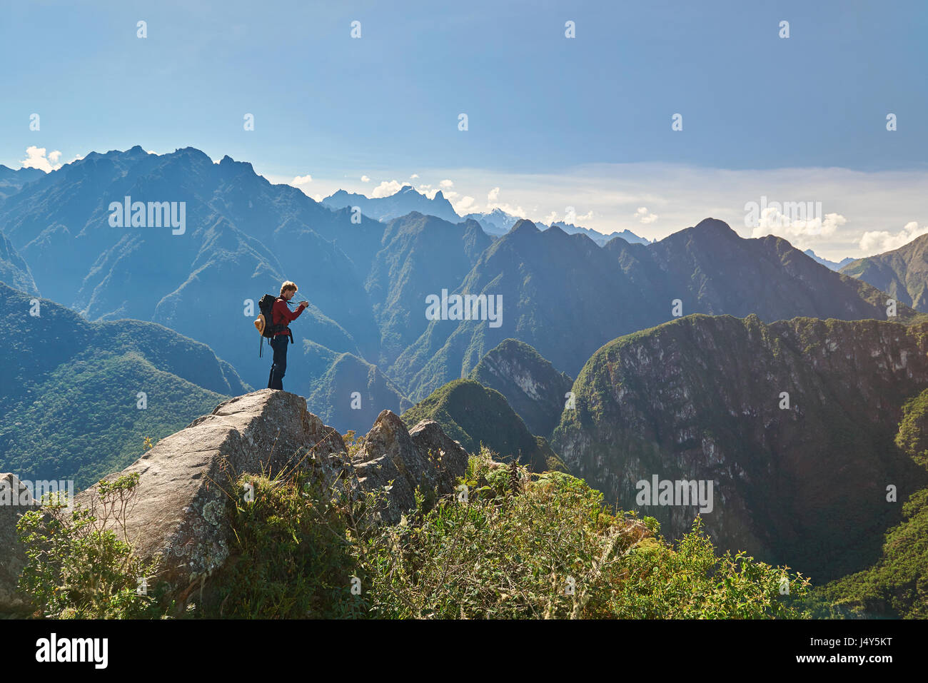 Machu Picchu, Peru - 22. April 2017. Mann mit Kamera am Gipfel des Berges. Ein Mann in Berge Gipfel wandern Stockfoto