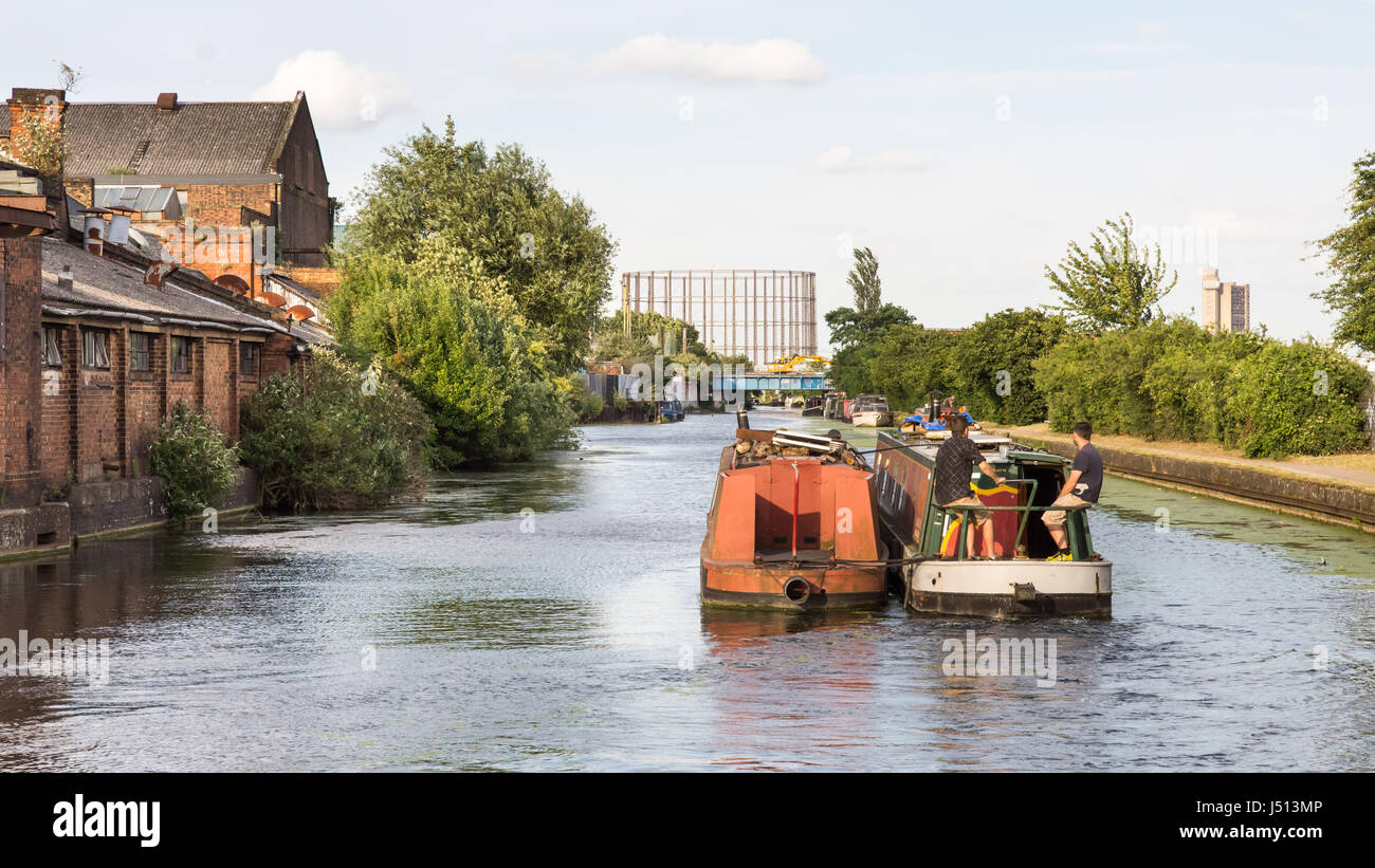 London, England - 10. Juli 2016: Traditionelle Narrowboats auf den Canal Grande Union übergeben verfallene Industriehallen und Lagerhallen in Old Oak Common in W Stockfoto