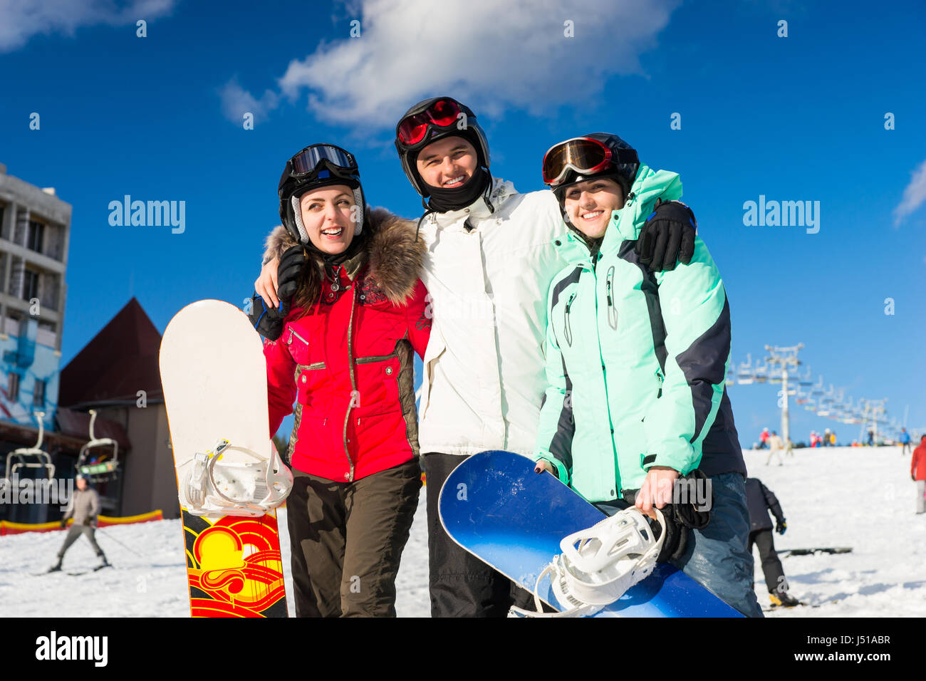 Jugend in Ski-Anzüge und Ski goggles Spaß beim stehen mit Snowboards in einem Skigebiet im Winter Stockfoto