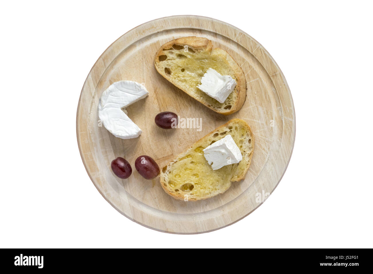 Geröstetem Sauerteig und Ziegenkäse auf einem Brot-Brett Stockfoto