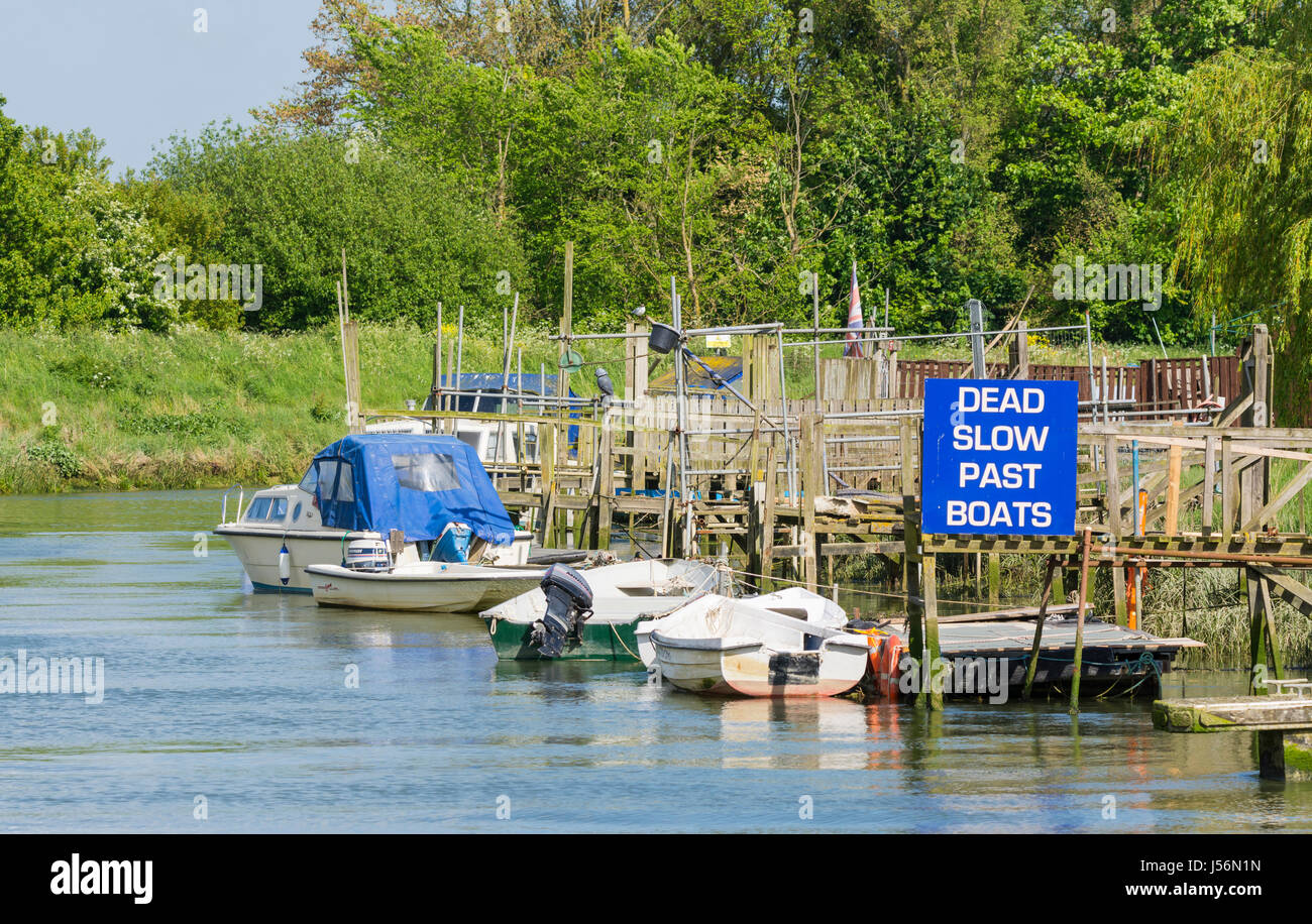 Toten langsamen letzten Boote Zeichen neben ankern Boote auf dem Fluss Arun auf dem Lande in Arundel, West Sussex, England, UK. Stockfoto