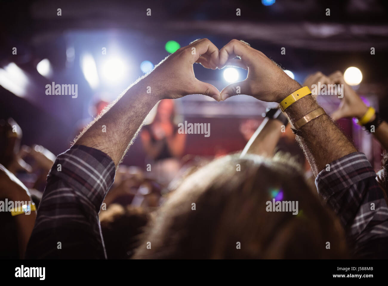Fans machen Herzform mit Händen beim Nachtclub Duing Music festival Stockfoto
