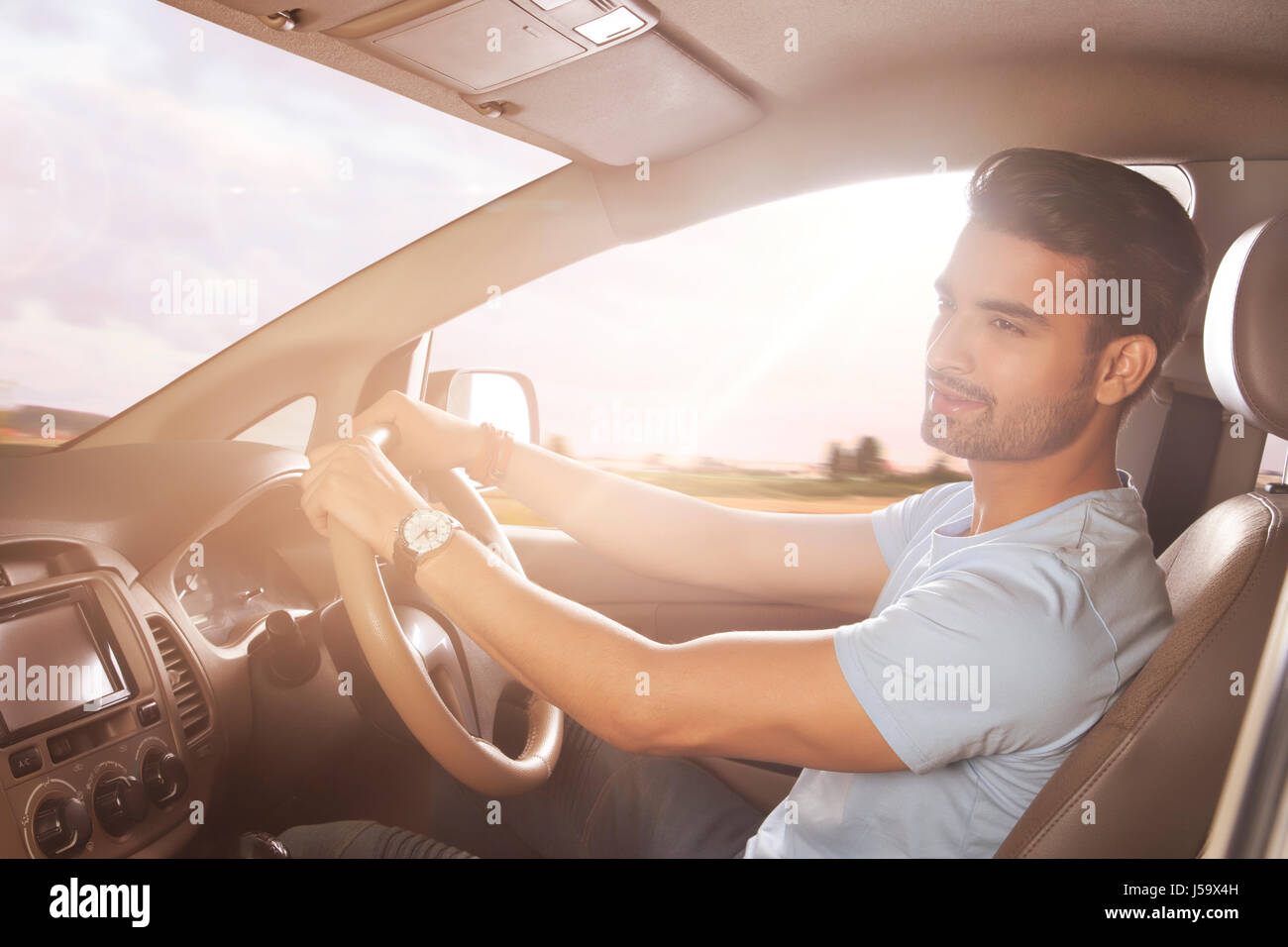 Junger Mann, ein Auto zu fahren Stockfoto