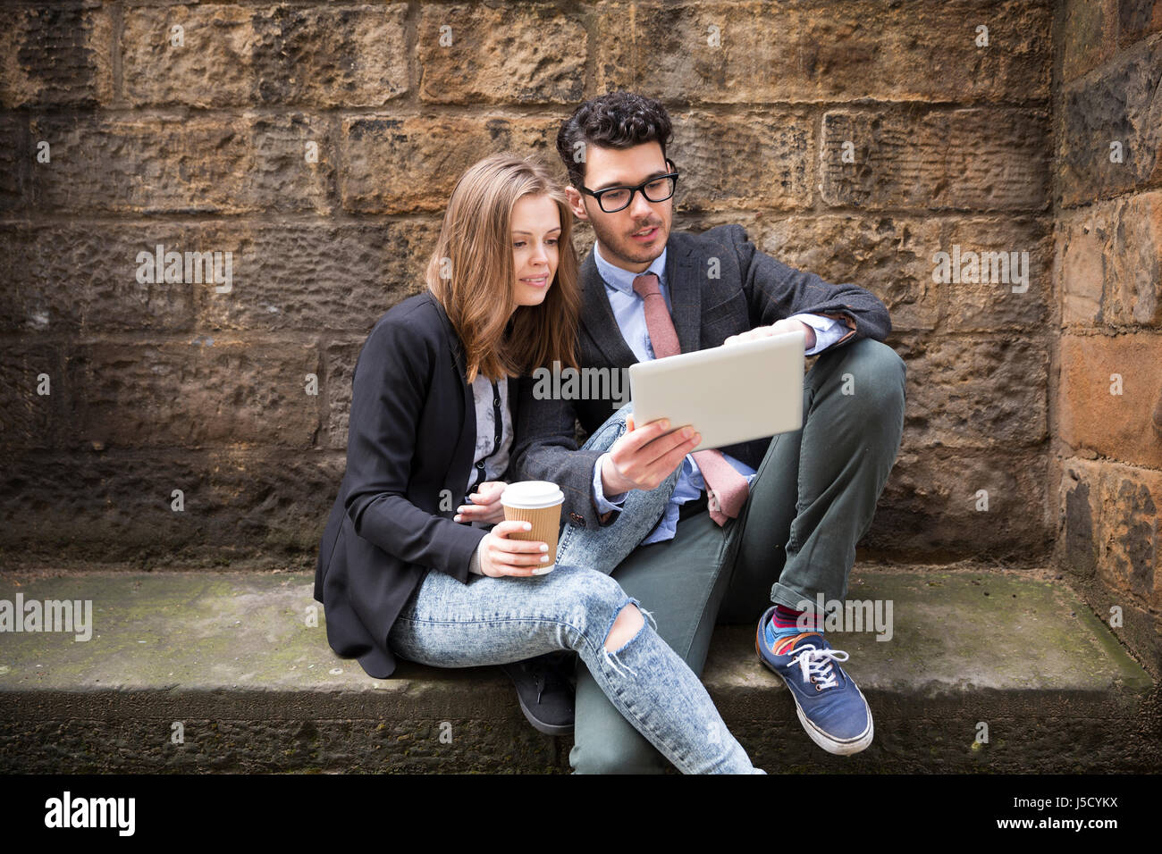 Stilvolle kaukasischen paar mit einem digitalen Tablet im Freien in der Stadt. Stockfoto