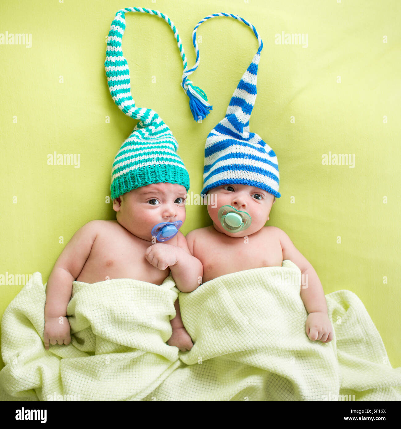 Zwillinge Baby Brüder Babys weared in gestreiften Hüte gebunden auswendig. Stockfoto