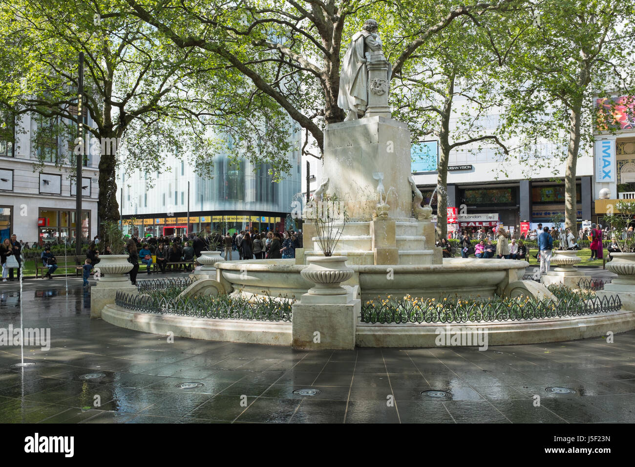 Touristen rund um den Brunnen am Londoner Leicester Square Stockfoto